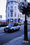 A Black Cab Passes by Trafalgar SQ